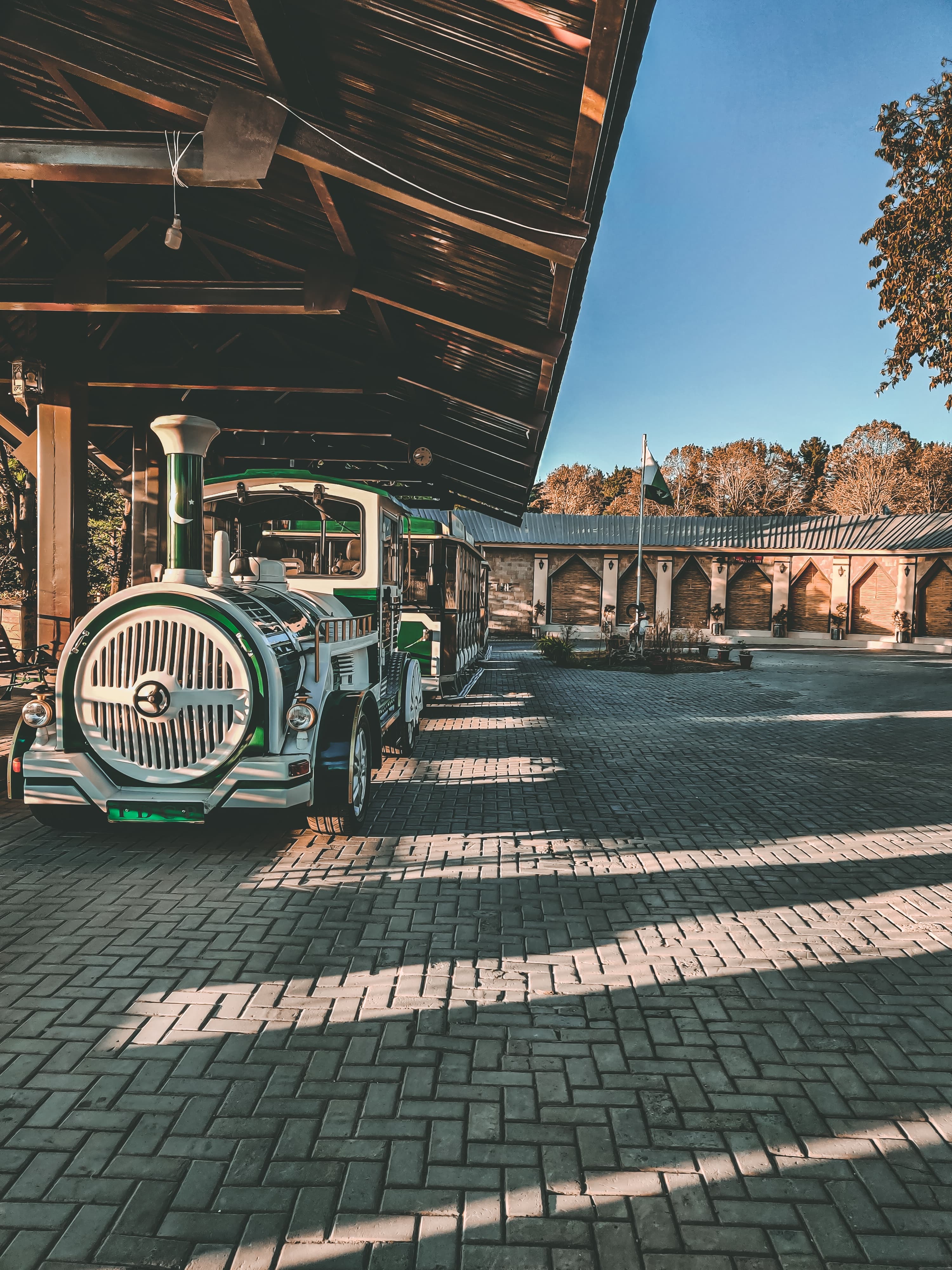 A stylized shot of a white and green tourist train...